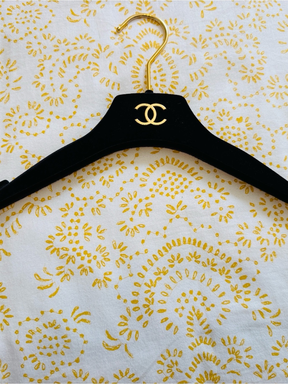 CHANEL Luxury Black Velvet Hanger with Gold Logo.